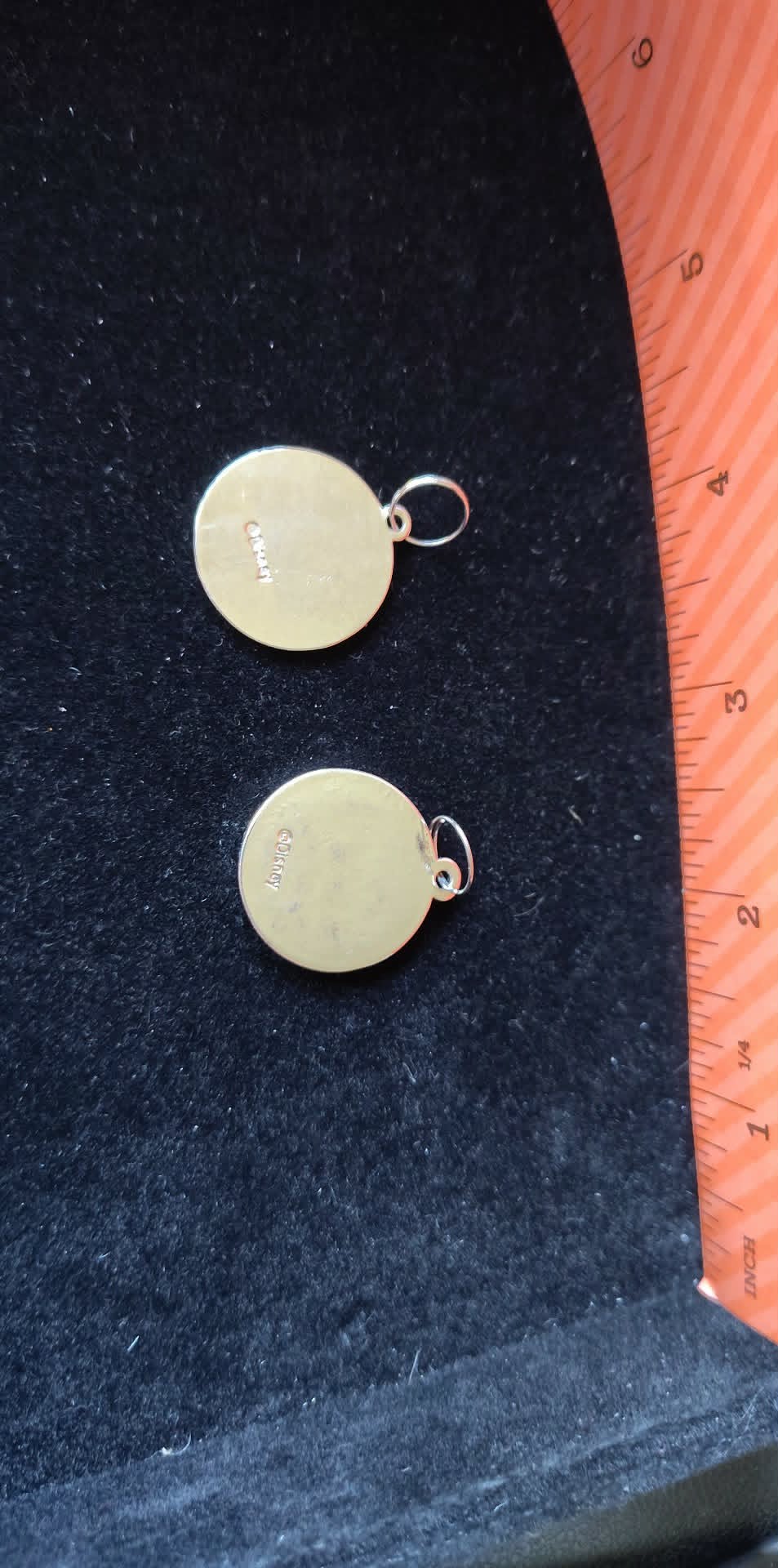 2 Circle silver-toned Disney pendants, one enameled
