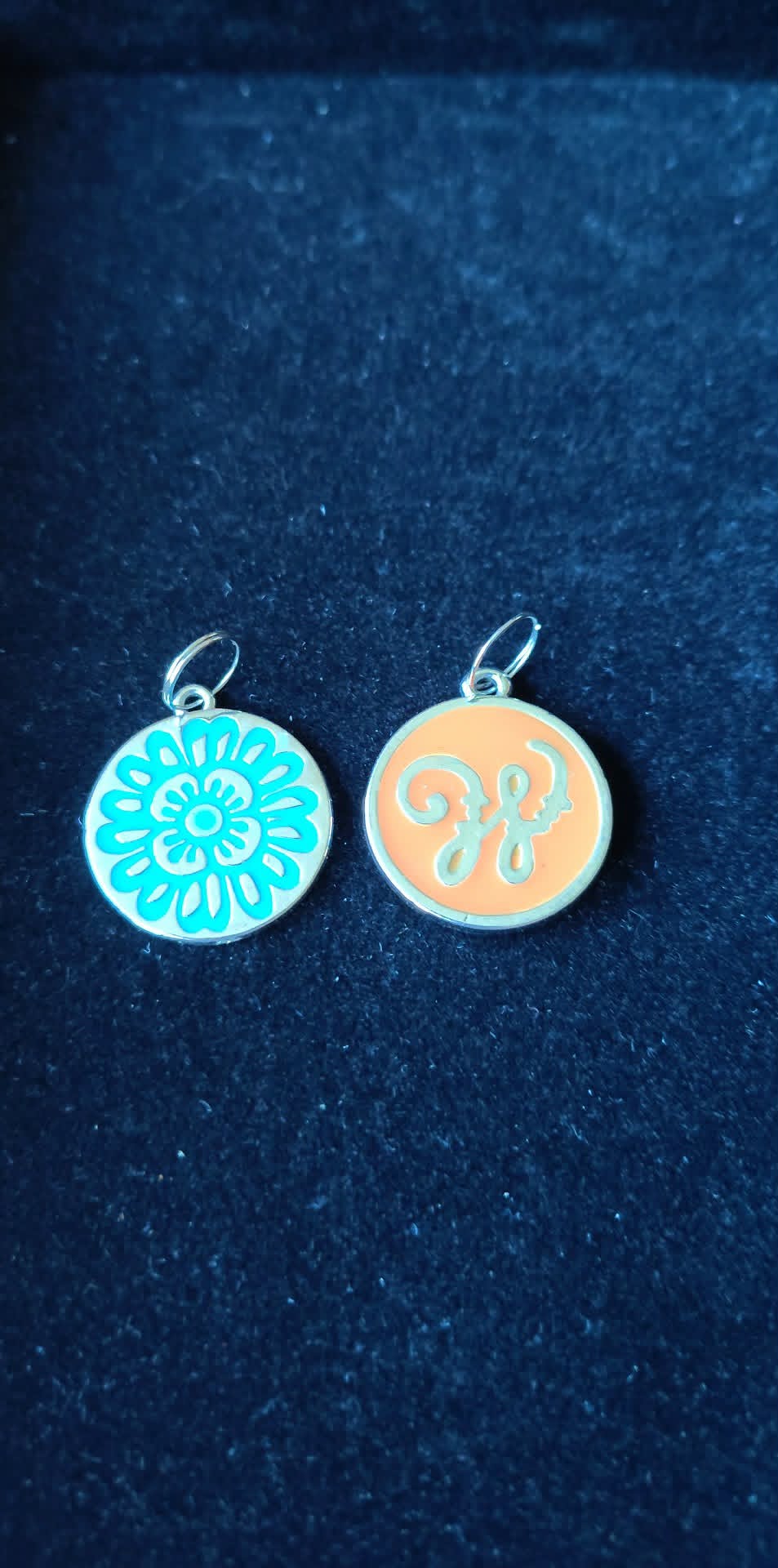2 Circle silver-toned Disney pendants, one enameled